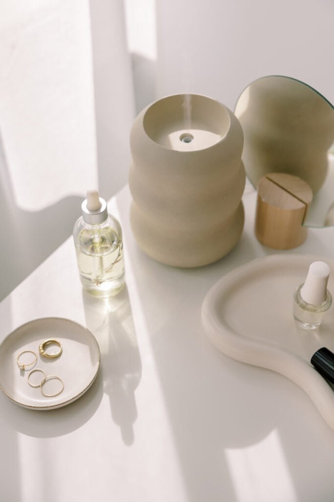Natural beauty station with glass dropper bottles and diffuser for creating homemade scalp treatment formulations