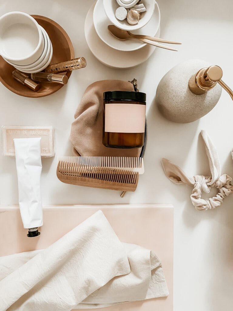 Natural hair care tools and amber glass containers arranged for creating DIY scalp treatment recipes