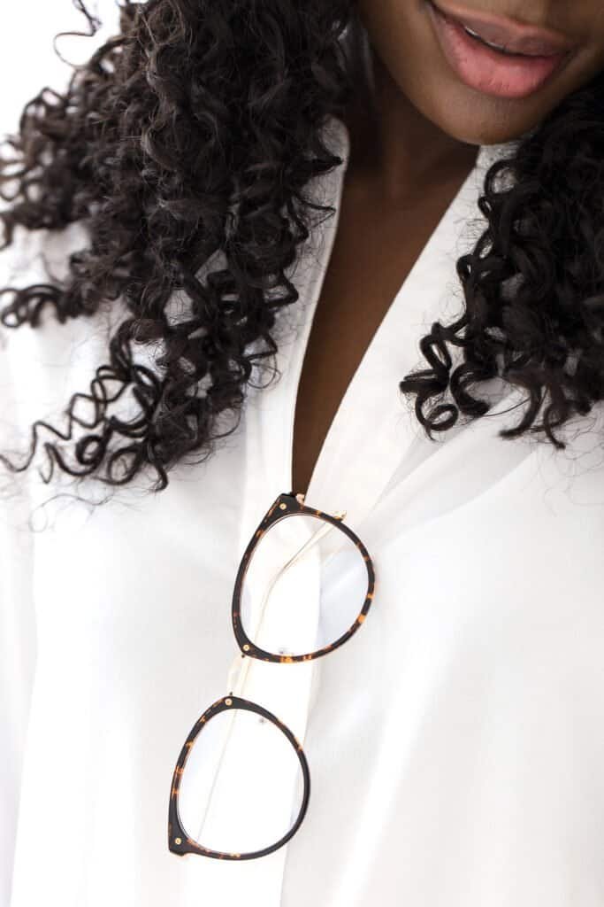 Woman with healthy, voluminous curly hair after natural dandruff treatment - illustrating successful scalp health restoration