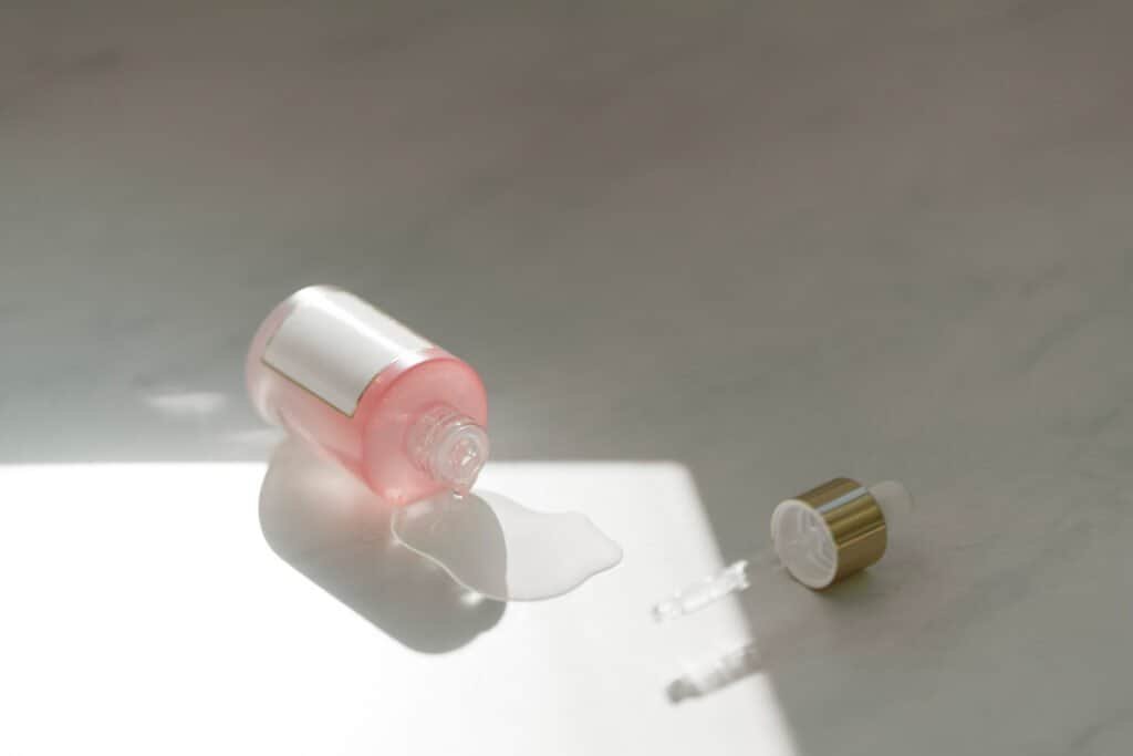 Natural scalp serum or oil treatment being dispensed for the 5-pillar approach to eliminate dandruff naturally