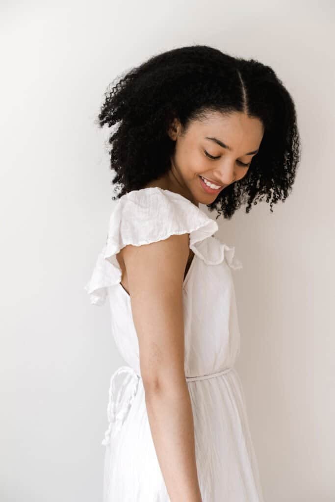 Woman with beautiful natural textured hair demonstrating healthy hair growth from good scalp health care