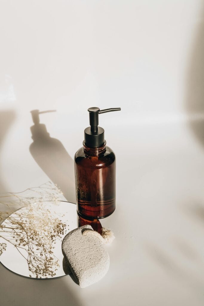 Quality amber glass shampoo bottle representing gentle moisturizing formulas that preserve beneficial lipids for healthy frequent washing routine