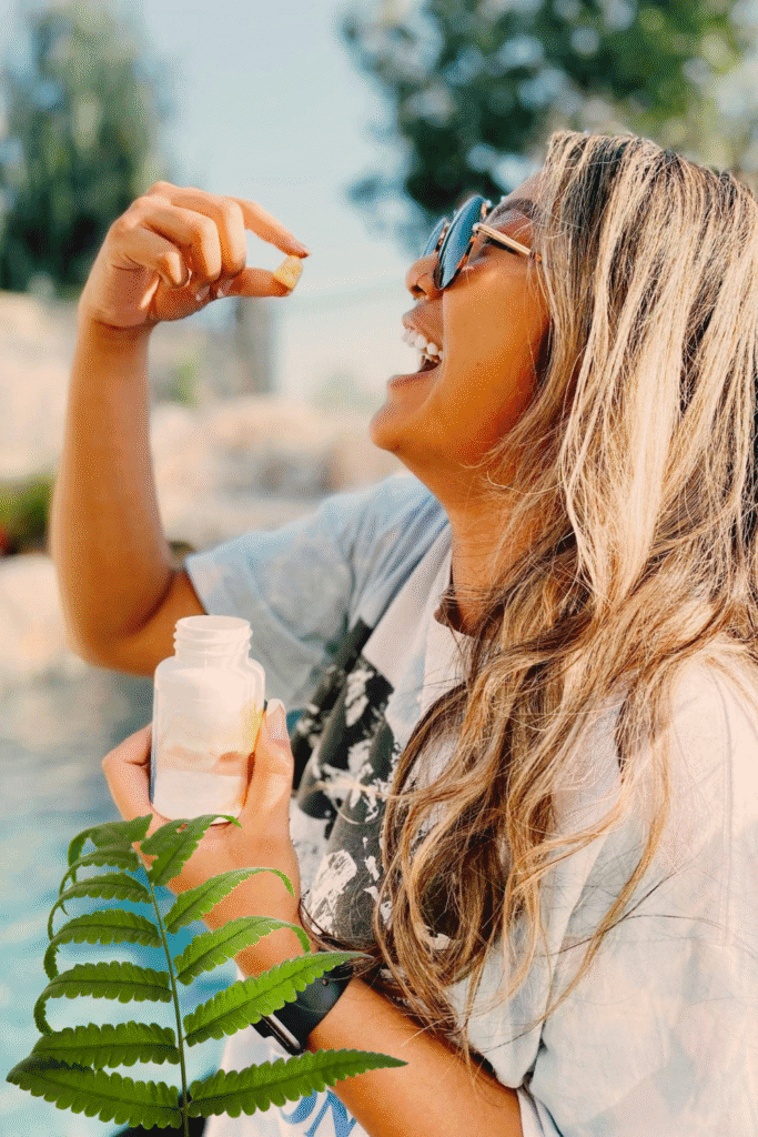 Woman taking Polypodium leucotomos supplement outdoors for inside-out sun protection